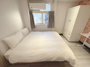 Kama o mga kama sa kuwarto sa 新獅城商務旅館New Lion City Hotel