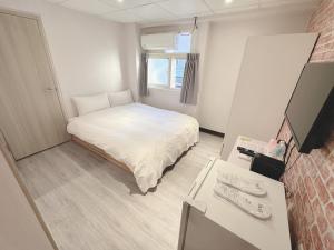 Kama o mga kama sa kuwarto sa 新獅城商務旅館New Lion City Hotel