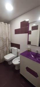 La salle de bains est pourvue de toilettes blanches et d'un lavabo. dans l'établissement Casa TARA, à Santa Pola