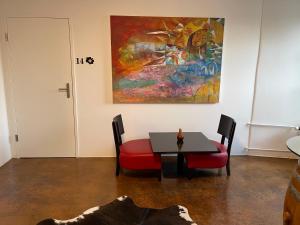 a dining room with a table and a painting on the wall at Hotel Swiss Bellevue Aathal in Seegräben