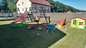 a playground with a slide and play equipment on the grass at 11 Maków in Mielenko