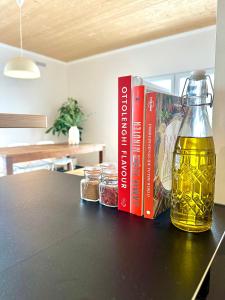 a bottle of beer and two books on a table at Modern & Stylisch Penthouse - 112m2 - München&Airport in Freising