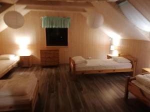 a large room with two beds and a television at 11 Maków in Mielenko