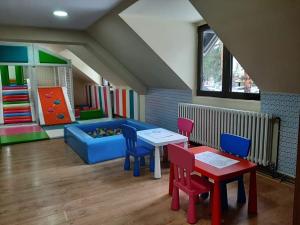 a living room with a couch and a table and chairs at Hotel Pepa in Divčibare +23 photos
