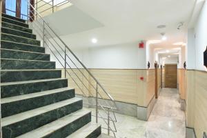 a staircase in a building with green steps at Hotel Hari Piorko Grand - New Delhi Railway Station in New Delhi