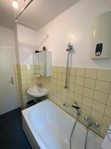 a bathroom with a tub and a sink at Wiesbaden Mainz kostheim Bitte nur für männliche Only Men Gäste in Wiesbaden