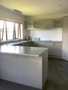a kitchen with white cabinets and a counter top at City haven in Whanganui