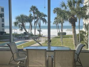 a table and chairs with a view of the beach at Island House Beach Resort 14N in Siesta Key