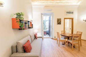 a living room with a couch and a table at Atelier dello Statuto, a few steps from Colosseo in Rome +17 photos