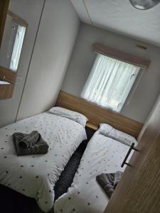 two beds in a small room with two windows at 53 Kingsgate Lower Hyde in Shanklin