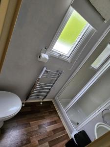 a bathroom with a toilet and a window at 53 Kingsgate Lower Hyde in Shanklin