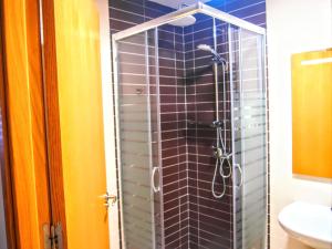 a glass shower in a bathroom with a sink at Alojamiento Rural Los Gancheros in Tragacete