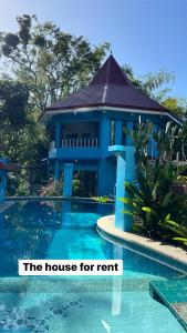 a house for rent next to a swimming pool at Heaven’s Gate Resort in Puerto Galera
