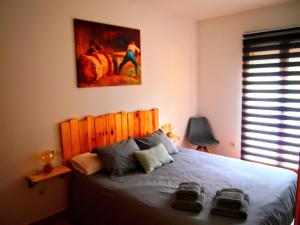 a bedroom with a bed with two towels on it at Alojamiento Rural Los Gancheros in Tragacete
