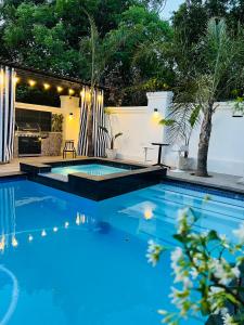 a blue swimming pool with a table in a backyard at 435 on vale boutique aparthotel in Johannesburg