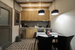 a kitchen with a table and chairs in a room at SaltHouse #4 in Kalabaka