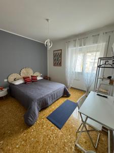 a bedroom with a bed and a table and a chair at Urban cosy rooms in Rome