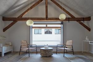 a living room with two chairs and a table at Kocanda Kravsko in Kravsko