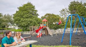 two people sitting at a bench in a playground at 53 Kingsgate Lower Hyde in Shanklin