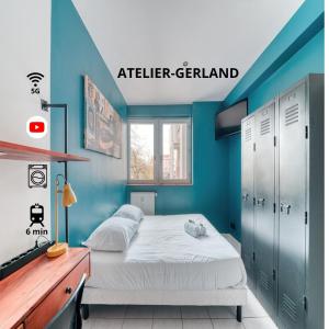 a bedroom with a bed and a blue wall at Atelier-Gerland in Lyon