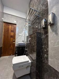 a bathroom with a toilet and a sink at GK Homestays - Luxurious Furnished Apartment in Salem
