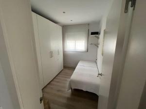 a white room with a bench and a window at House in Sant Cugat, 25 Mins to Barcelona center in Sant Cugat del Vallès