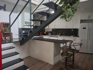 a staircase in a kitchen with a counter and a table at House in Sant Cugat, 25 Mins to Barcelona center in Sant Cugat del Vallès