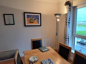 a dining room with a table and a window at 203 Harbour Mill in Westport