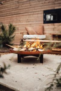 a table with a fire in it in front of a building at Tiny Dream House 4p in Arnhem