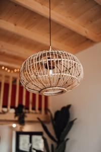 a wicker light fixture hanging from a ceiling at Tiny Dream House 4p in Arnhem