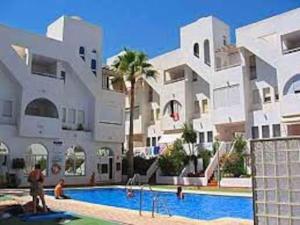 um edifício com piscina em frente a um edifício em Garrucha's Beach Aldea Marina em Vera