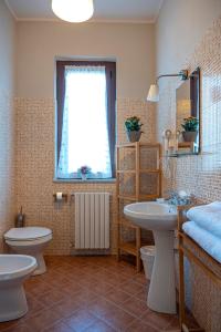 VanzagoにあるLe Case nel Boscoのバスルーム(洗面台、トイレ付)、窓が備わります。