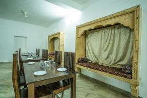 a room with a row of tables and mirrors at Sandcastle Resort in Jaisalmer