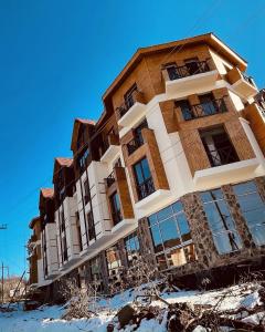 a building in the snow in front at Bakuriani Mix 213 in Bakuriani