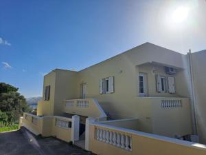 a building with a balcony with stairs on it at ENDLESS VIEWS PANTELI LEROS in Panteli