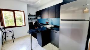 a kitchen with a refrigerator and a table in it at Wide Family Apartment in the new Center of Casablanca in Casablanca