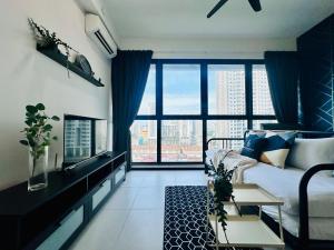 a living room with a bed and a large window at Urban Suites Homestay WL in Jelutong