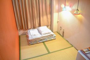 Postel nebo postele na pokoji v ubytování Yokohama Hostel Village Hayashi-Kaikan