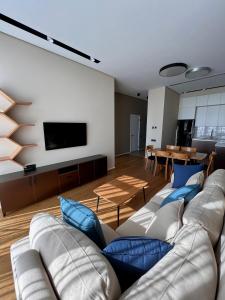 a living room with a couch and a tv at Sea breeze Lighthouse 2 in Baku