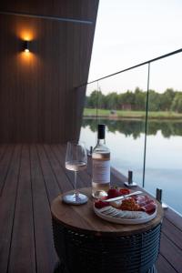 a bottle of wine and a plate of food and a glass at Edge Luxury Villas in Wilyabrup +22 photos