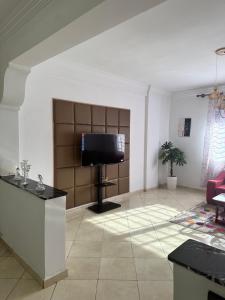 a living room with a flat screen tv on a stand at Appartement à beni mellal in Beni Mellal