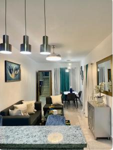a living room with couches and a dining room at Residencial García 1 apt 3 in La Romana