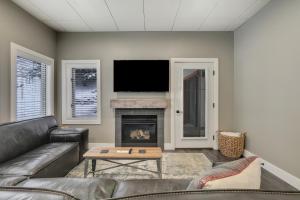 a living room with a couch and a fireplace at 621 Disciples Village in Boyne Falls