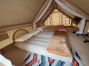a bedroom with a bed in a tent at De Kampung Campsite in Rawang