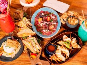 a wooden table with plates of food on it at Novotel Avignon Nord in Sorgues