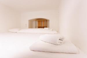 Llit o llits en una habitació de Urban Capsule Apartment - Near Mariahilfer Straße