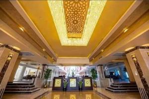 a lobby with a yellow ceiling and stairs at Beach for Couples & Family - Hurghada - Free Fast Wi Fi in Hurghada