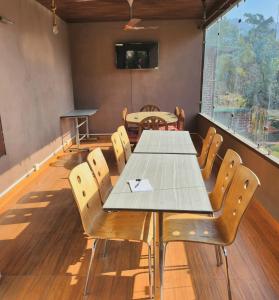 a conference room with a table and chairs at Aum 108 Retreat - Rishikesh Mountains in Rishīkesh