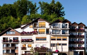 a large white building with balconies and trees at Hotel Renchtalblick in Oberkirch