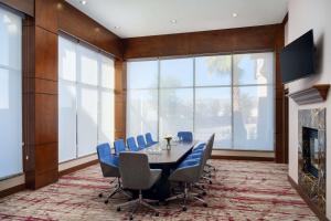 a conference room with a table and chairs and a fireplace at Hilton Garden Inn El Paso Airport in El Paso
